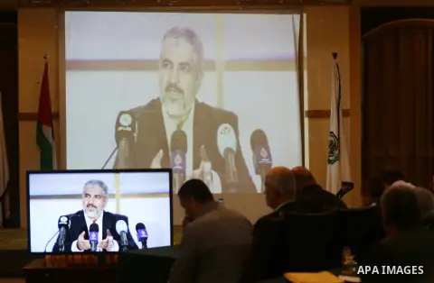 Hamas chief Khaled Mashaal, speaks via video conference during a meeting to announce Hamas political document (the document of general principles and policies), in Gaza city on May 01, 2017. Photo by Mohammed Asad