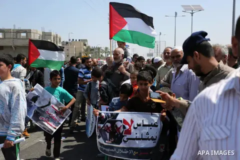 Palestinians hold a poster depicting Palestinian President Mahmoud Abbas during a protest against the blockade in Dair Al Balah, in the center of Gaza strip on May 2, 2017 demanding an end to the one-decade-old Israeli s...