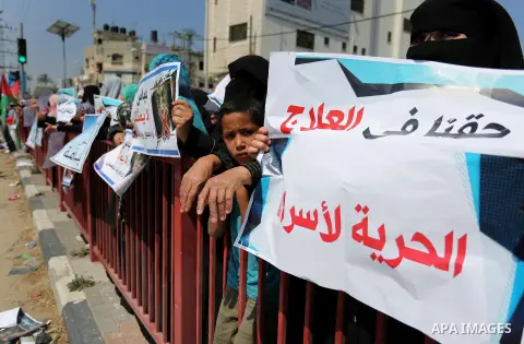 Palestinians hold a poster depicting Palestinian President Mahmoud Abbas during a protest against the blockade in Dair Al Balah, in the center of Gaza strip on May 2, 2017 demanding an end to the one-decade-old Israeli s...