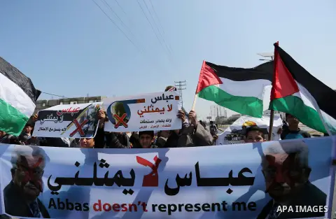 Palestinians hold a poster depicting Palestinian President Mahmoud Abbas during a protest against the blockade in Dair Al Balah, in the center of Gaza strip on May 2, 2017 demanding an end to the one-decade-old Israeli s...