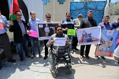 Palestinian Journalists hold banners during a protest calling for stop the Israeli violence against journalists on the occasion of World Press Freedom day in front of the high commissioner for human rights headquarters,...