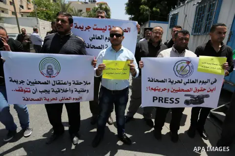 Palestinian Journalists hold banners during a protest calling for stop the Israeli violence against journalists on the occasion of World Press Freedom day in front of the high commissioner for human rights headquarters,...