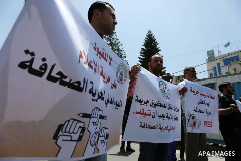 Palestinian Journalists hold banners during a protest calling for stop the Israeli violence against journalists on the occasion of World Press Freedom day in front of the high commissioner for human rights headquarters,...