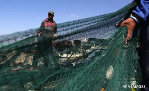 Palestinian fishermen pull their net at the beach of Gaza City, on May 03, 2017. Israel has eased restrictions on Gaza fishermen, allowing them to travel up to nine nautical miles off the coast of the blockaded territory...
