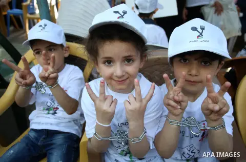 Palestinian children take part in a protest to show solidarity with Palestinian prisoners on hunger strike in Israeli jails, in the West Bank city of Nablus, on May 4, 2017. Photo by Ayman Ameen
