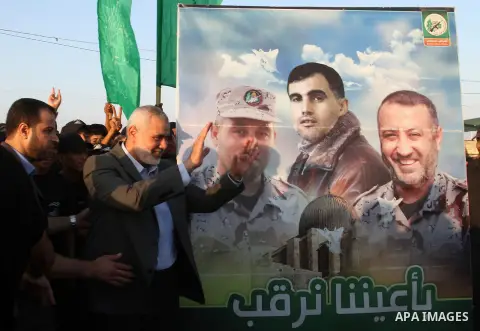 (FILES) This file photo taken on August 1, 2015 shows Senior Hamas leader Ismail Haniyeh waves as he arrives to Liberation Youths summer camp, organised by the Hamas movement, in Rafah in the southern Gaza Strip. Ismail...