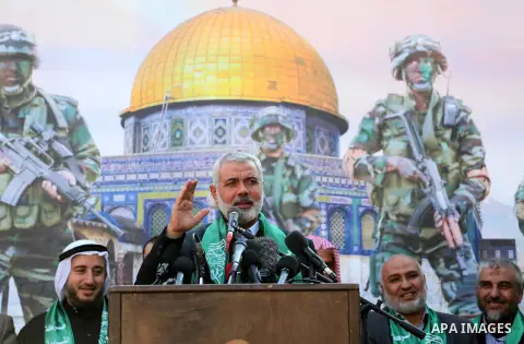 (FILES) This file photo taken on December 11, 2015 shows Senior Hamas leader Ismail Haniyeh speaks during a military parade of members of al-Qassam Brigades, the armed wing of the Hamas movement, to mark the 28th anniver...