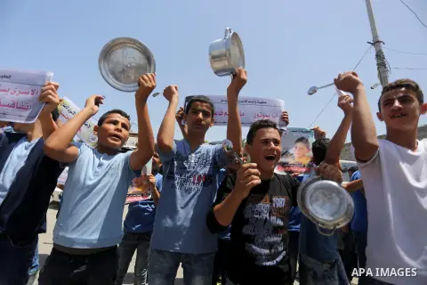 Palestinian children hold banners during a sit-in in support of Palestinian hunger-striking prisoners held in Israeli jails in front of the headquarter United Nation "UNSCO", on May 9, 2017, in Gaza City. Photo by Mohamm...