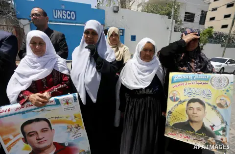 Palestinians hold banners during a sit-in in support of Palestinian hunger-striking prisoners held in Israeli jails in front of the headquarter United Nation "UNSCO", on May 9, 2017, in Gaza City. Photo by Mohammed Asad