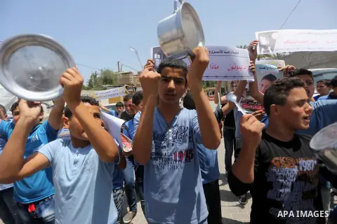 Palestinian children hold banners during a sit-in in support of Palestinian hunger-striking prisoners held in Israeli jails in front of the headquarter United Nation "UNSCO", on May 9, 2017, in Gaza City. Photo by Mohamm...