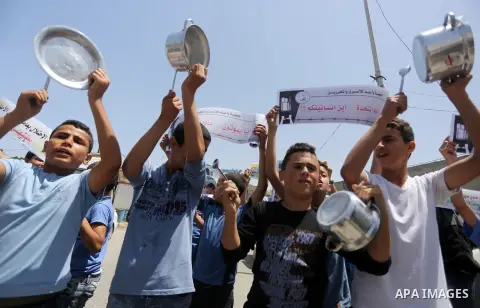 Palestinian children hold banners during a sit-in in support of Palestinian hunger-striking prisoners held in Israeli jails in front of the headquarter United Nation "UNSCO", on May 9, 2017, in Gaza City. Photo by Mohamm...