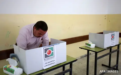 A Palestinian man casts his ballot at a polling station during municipal elections in the West Bank of Nablus on May 13, 2017. Photo by Ayman Ameen