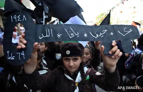 Palestinian scouts take part in a rally to commemorate the 69th anniversary of the "Nakba" in the West Bank city of Nablus, on May 15, 2017. "Nakba" means in Arabic "catastrophe" in reference to the birth of the state of...