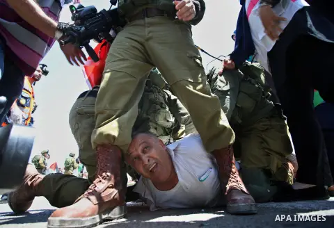 Israeli soldiers detain a Palestinian protester trying to block the main road between the West Bank city of Nablus and the Jewish settlement of Shavi Shamron during a demonstration in solidarity with Palestinian prisoner...
