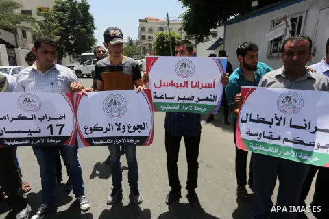 Palestinian supporters of Al-Ahrar movement take part in a protest to show solidarity with Palestinian prisoners on hunger strike in Israeli jails in front of the high commissioner for human rights headquarters, in Gaza...