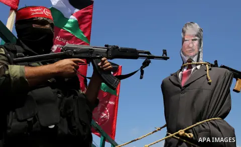 Palestinian militants from the Popular Front for the Liberation of Palestine (PFLP) aim their weapons at an effigy depicting U.S. President Donald Trump, in Gaza City May 23, 2017. Photo by Ashraf Amra