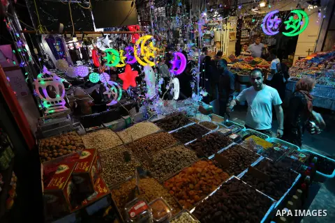 A Palestinian vendor sells pickles at a market ahead of the Muslim holy month of Ramadan, in Gaza city, on May 25, 2017 as the faithful prepare to start fasting. Photo by Ashraf Amra