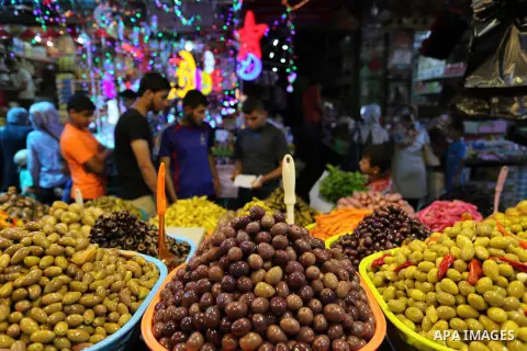 A Palestinian vendor sells pickles at a market ahead of the Muslim holy month of Ramadan, in Gaza city, on May 25, 2017 as the faithful prepare to start fasting. Photo by Ashraf Amra