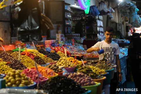A Palestinian vendor sells pickles at a market ahead of the Muslim holy month of Ramadan, in Gaza city, on May 25, 2017 as the faithful prepare to start fasting. Photo by Ashraf Amra
