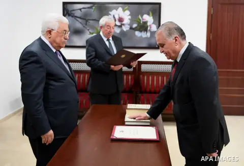 Palestinian President Mahmoud Abbas attends a ceremonial swearing of the head and members of Fatah court, in the West Bank of Ramallah on May 26, 2017. Photo by Osama Falah
