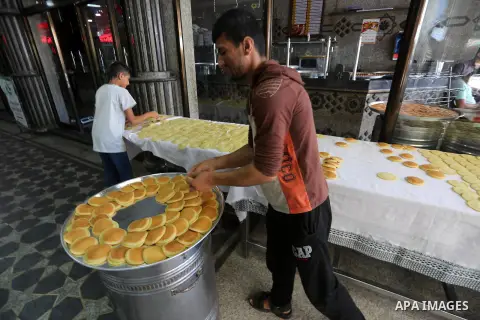 A Palestinian vendor prepares traditional pancakes known as ''Qatayef'' on the holy month of Ramadan at market in Gaza city on May 27, 2017. Ramadan is sacred to Muslims because it is during that month that tradition say...