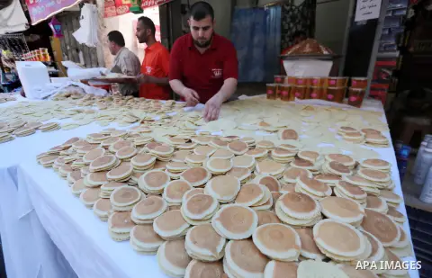 A Palestinian vendor prepares traditional pancakes known as ''Qatayef'' on the holy month of Ramadan at market in Gaza city on May 27, 2017. Ramadan is sacred to Muslims because it is during that month that tradition say...