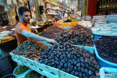 A Palestinian vendor sells dates and pickles on the holy month of Ramadan at market in Gaza city on May 27, 2017. Ramadan is sacred to Muslims because it is during that month that tradition says the Koran was revealed to...