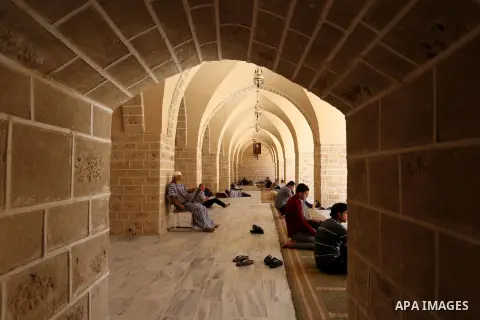 A Palestinian man reads a copy of the Koran, Islam's holiest book, on the first day of fasting in the Muslim holy month of Ramadan, at the al-Omari mosque in Gaza City, on May 27, 2017. Ramadan is sacred to Muslims becau...