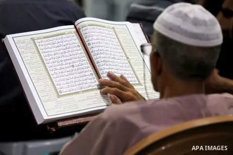 A Palestinian man reads a copy of the Koran, Islam's holiest book, on the first day of fasting in the Muslim holy month of Ramadan, at the al-Omari mosque in Gaza City, on May 27, 2017. Ramadan is sacred to Muslims becau...