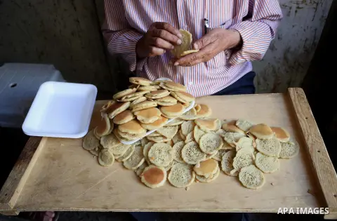 A Palestinian vendor sells traditional pancakes known as ''Qatayef'' on the Muslim holy fasting month of Ramadan at his shop in the Old City of the West Bank town of Nablus on May 28, 2017. Ramadan is sacred to Muslims b...