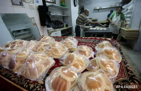 A Palestinian vendor prepares traditional pancakes known as ''Qatayef'' on the Muslim holy fasting month of Ramadan at his shop in the Old City of the West Bank town of Nablus on May 28, 2017. Ramadan is sacred to Muslim...