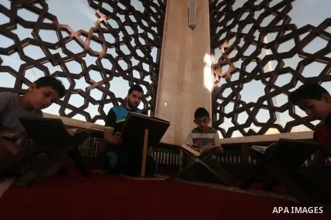 Palestinian boys read a copy of the Koran, Islam's holiest book, on the Muslim holy fasting month of Ramadan at al-Khaldi mosque in Gaza city on May 31, 2017. Ramadan is sacred to Muslims because it is during that month...