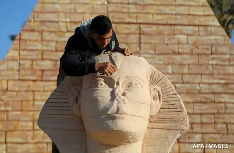 A Palestinian artist works on a wooden sculpture of sphinx at a technical site in the southern Gaza Strip town of Rafah, near the border with Egypt, on June 1, 2017. Young artists Palestinian artists Nidal Al-Jarami and...