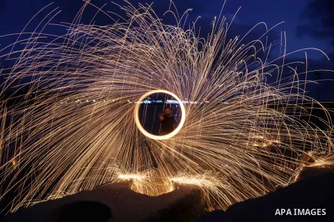 A Palestinian man plays with fire crackers celebrating on the holy month of Ramadan at the seaport of Gaza city, on June 1, 2017. Ramadan is sacred to Muslims because it is during that month that tradition says the Koran...