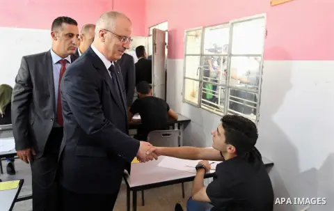 Palestinian Prime Minister Rami Hamdallah visits a school during the first day of high school exams, known as "Tawjihi" in the West Bank city of Nablus on June 03, 2017. Photo by Prime Minister Office