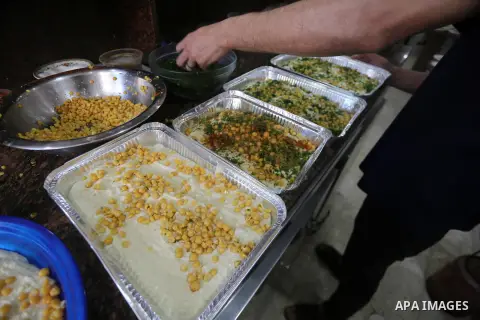 A Palestinian vendor prepares chickpeas known as "Hummus" for breakfasting on the Muslim holy fasting month of Ramadan in Gaza city, on June 03, 2017. Ramadan is sacred to Muslims because it is during that month that tra...