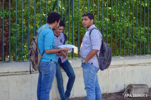 Egyptian students stand outside their school in the first day of high school exams, in Cairo, Egypt, on June 04, 2017. Photo by Amr Sayed