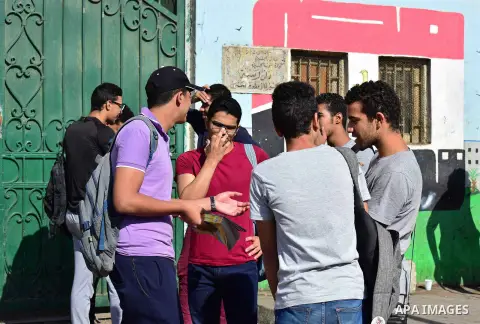 Egyptian students stand outside their school in the first day of high school exams, in Cairo, Egypt, on June 04, 2017. Photo by Amr Sayed