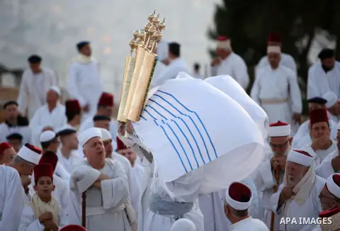 Samaritan worshipers pray on the top of Mount Gerizim in a traditional pilgrimage to mark the Shavuot's holiday at dawn near the West Bank city of Nablus June 4, 2017 which is giving of the Torah at Mount Sinai seven wee...
