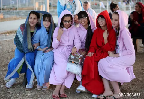Samaritan girls gather to pray on the top of Mount Gerizim in a traditional pilgrimage to mark the Shavuot's holiday at dawn near the West Bank city of Nablus June 4, 2017 which is giving of the Torah at Mount Sinai seve...