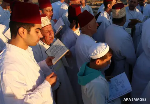 Samaritan worshipers pray on the top of Mount Gerizim in a traditional pilgrimage to mark the Shavuot's holiday at dawn near the West Bank city of Nablus June 4, 2017 which is giving of the Torah at Mount Sinai seven wee...