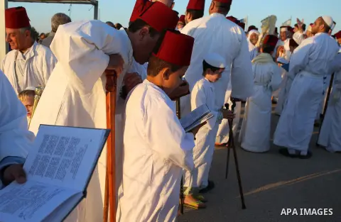 Samaritan worshipers pray on the top of Mount Gerizim in a traditional pilgrimage to mark the Shavuot's holiday at dawn near the West Bank city of Nablus June 4, 2017 which is giving of the Torah at Mount Sinai seven wee...