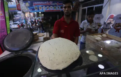 A Palestinian vendor prepares traditional bread known as "saj" for breakfasting on the Muslim holy fasting month of Ramadan in Gaza city on June 6, 2017. Ramadan is sacred to Muslims because it is during that month that...