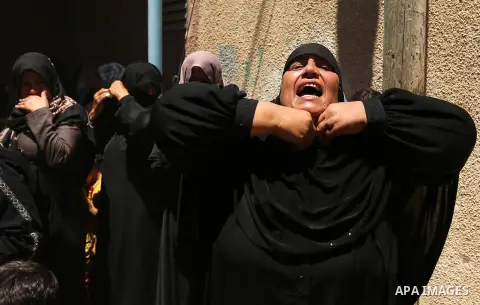 A Palestinian woman reacts during the funeral of a 25-year-old Palestinian Fadi al-Najjar who was killed by Israeli fire in the Gaza Strip during clashes with Israeli sceurity forces at the border fence the previous day,...