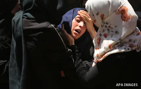 A Palestinian woman reacts during the funeral of a 25-year-old Palestinian Fadi al-Najjar who was killed by Israeli fire in the Gaza Strip during clashes with Israeli sceurity forces at the border fence the previous day,...