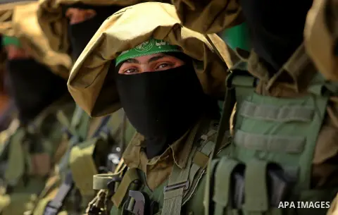 Members of the Ezzedine al-Qassam Brigades, the military wing of the Palestinian Islamist movement Hamas, attend the funeral of their comrade Ibrahim Abu Al-Naja in Rafah, southern Gaza Strip June 8, 2017. Photo by Ashra...