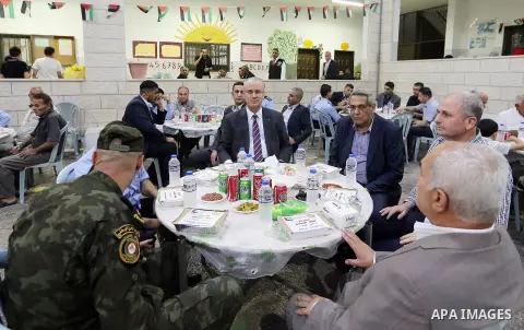 Palestinian Prime Minister Rami Hamdallah takes part in breakfast for orphans on holy fasting month of Ramadan, in the West Bank city of Tulkarem, on June 09, 2017. Photo by Prime Minister Office