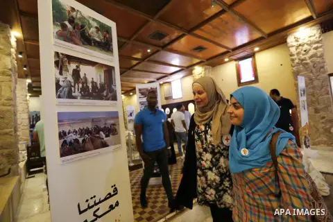 Palestinians participate in a photo gallery organized by Red cross (ICRC) on the occasion of over 50 years of its presence in the occupied Palestinian territories, in Gaza city on June 13, 2017. Photo by Ashraf Amra