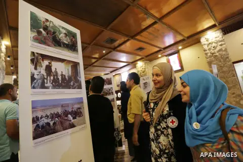 Palestinians participate in a photo gallery organized by Red cross (ICRC) on the occasion of over 50 years of its presence in the occupied Palestinian territories, in Gaza city on June 13, 2017. Photo by Ashraf Amra