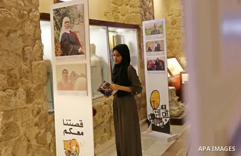 Palestinians participate in a photo gallery organized by Red cross (ICRC) on the occasion of over 50 years of its presence in the occupied Palestinian territories, in Gaza city on June 13, 2017. Photo by Ashraf Amra
